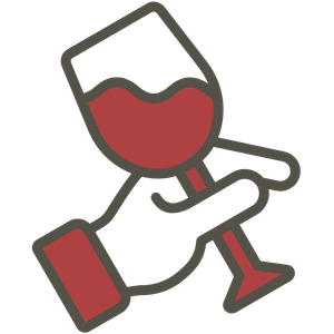 Hand holding a wine glass filled with red wine, tilted slightly to the left.