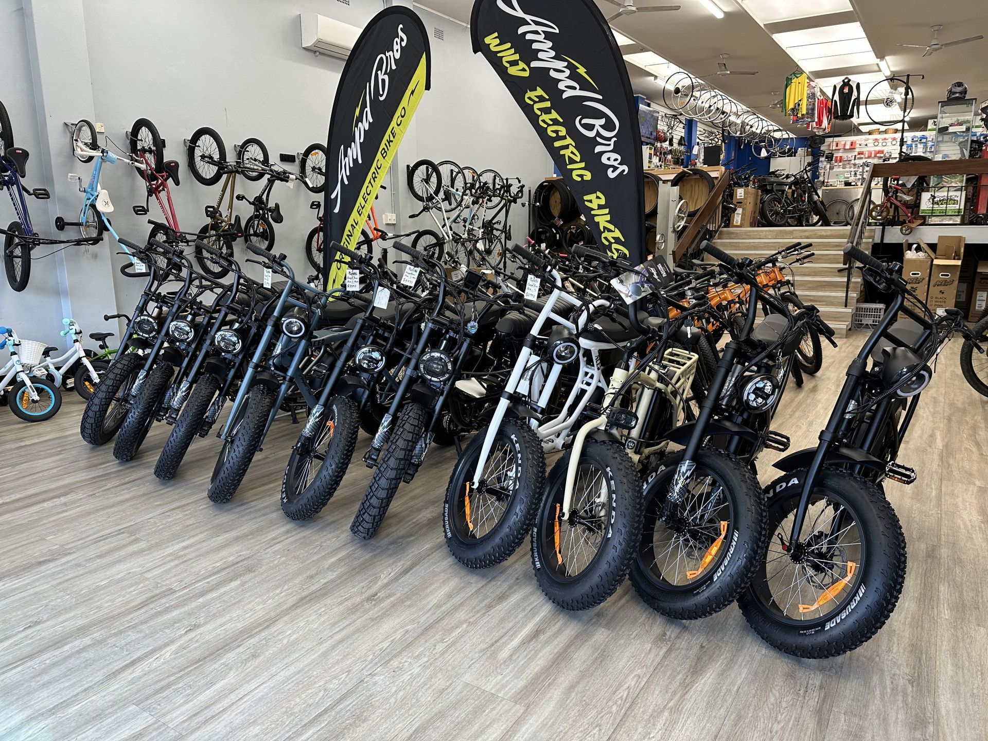 Row of black electric bikes displayed in a store, with 