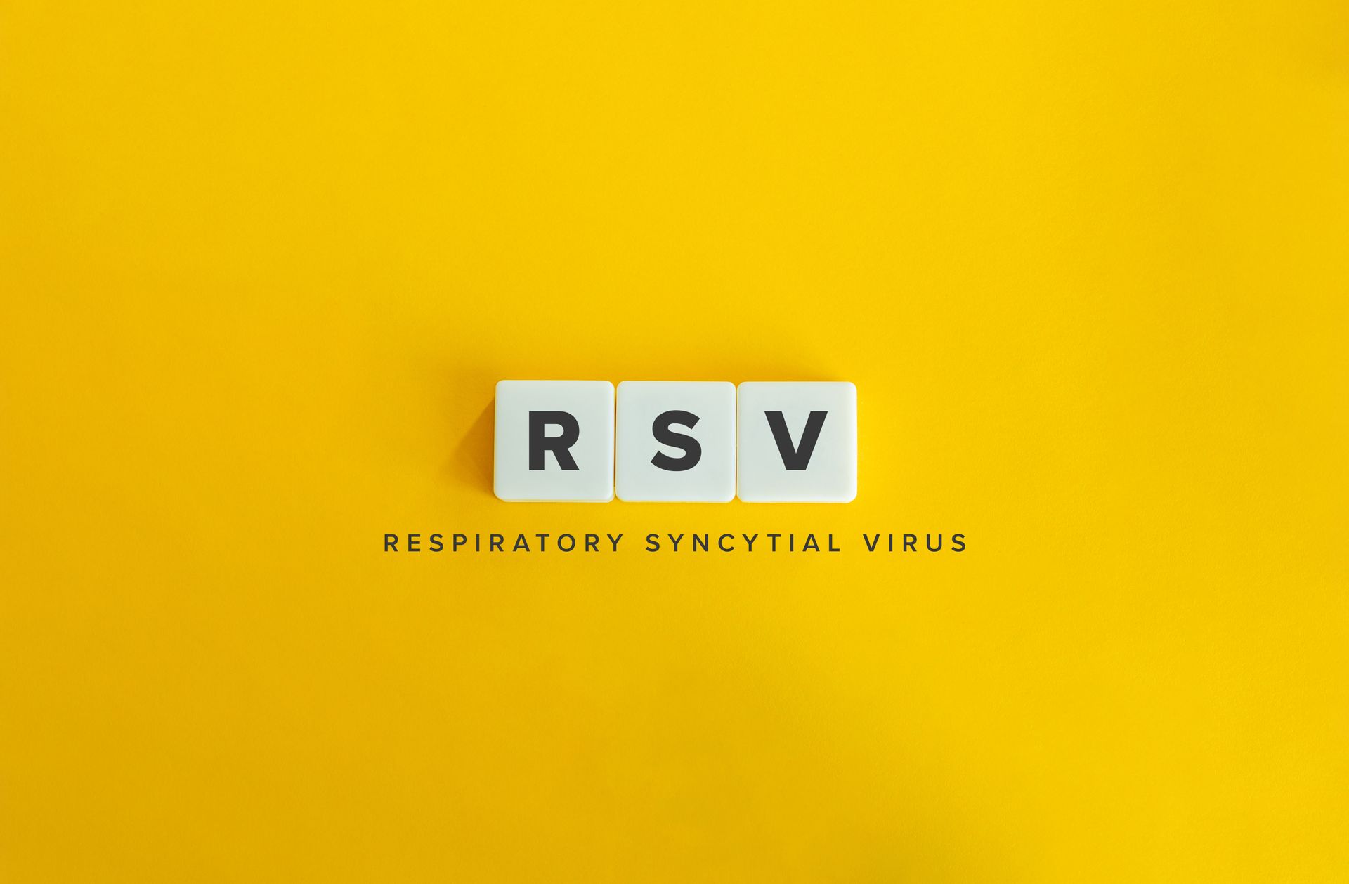 White blocks spelling RSV on a yellow background, with small text reading respiratory syncytial virus.