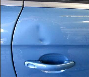 Blue Car Door With a Dent Above the Handle — FNQ Paintless Dent Repair in Edmonton, QLD