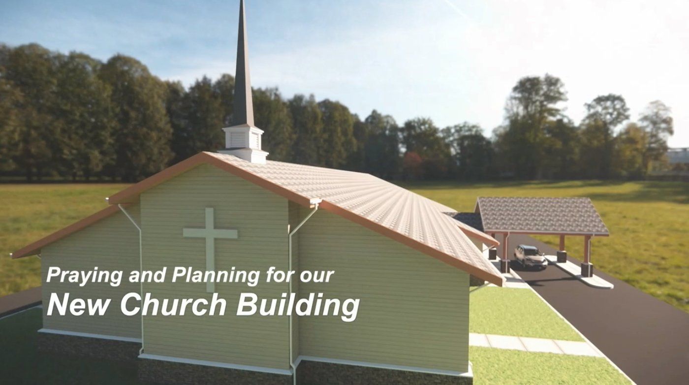 Illustration of a light green church building with a cross and steeple, set in a grassy field.