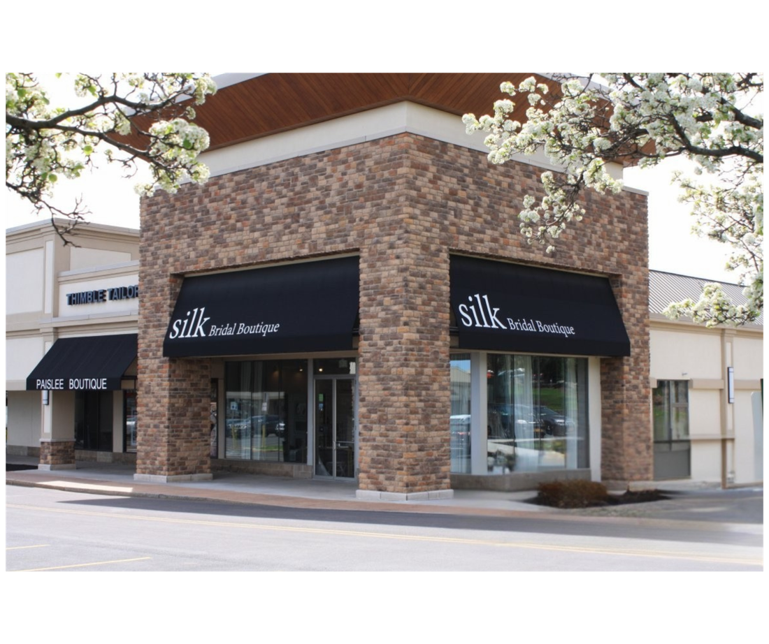 A store front with a black awning that says silk