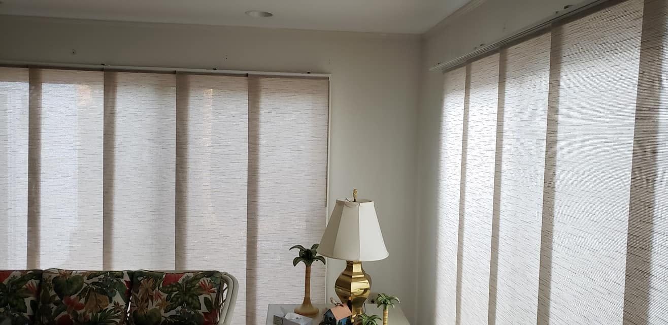 A living room with a couch and a lamp