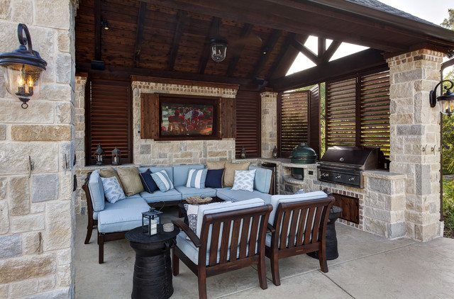 A patio with a couch , chairs , tables and a grill.