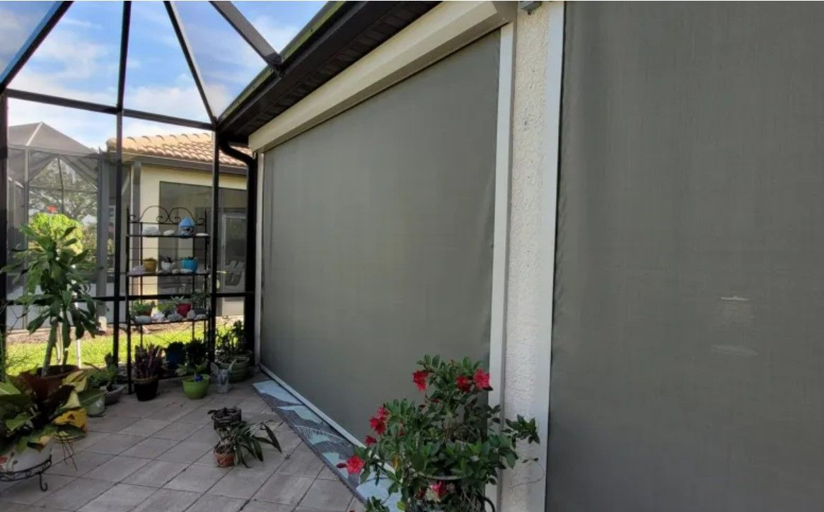 A house with a screened in porch and a patio with a screened in porch.