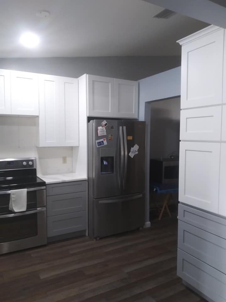 A kitchen with stainless steel appliances and white cabinets