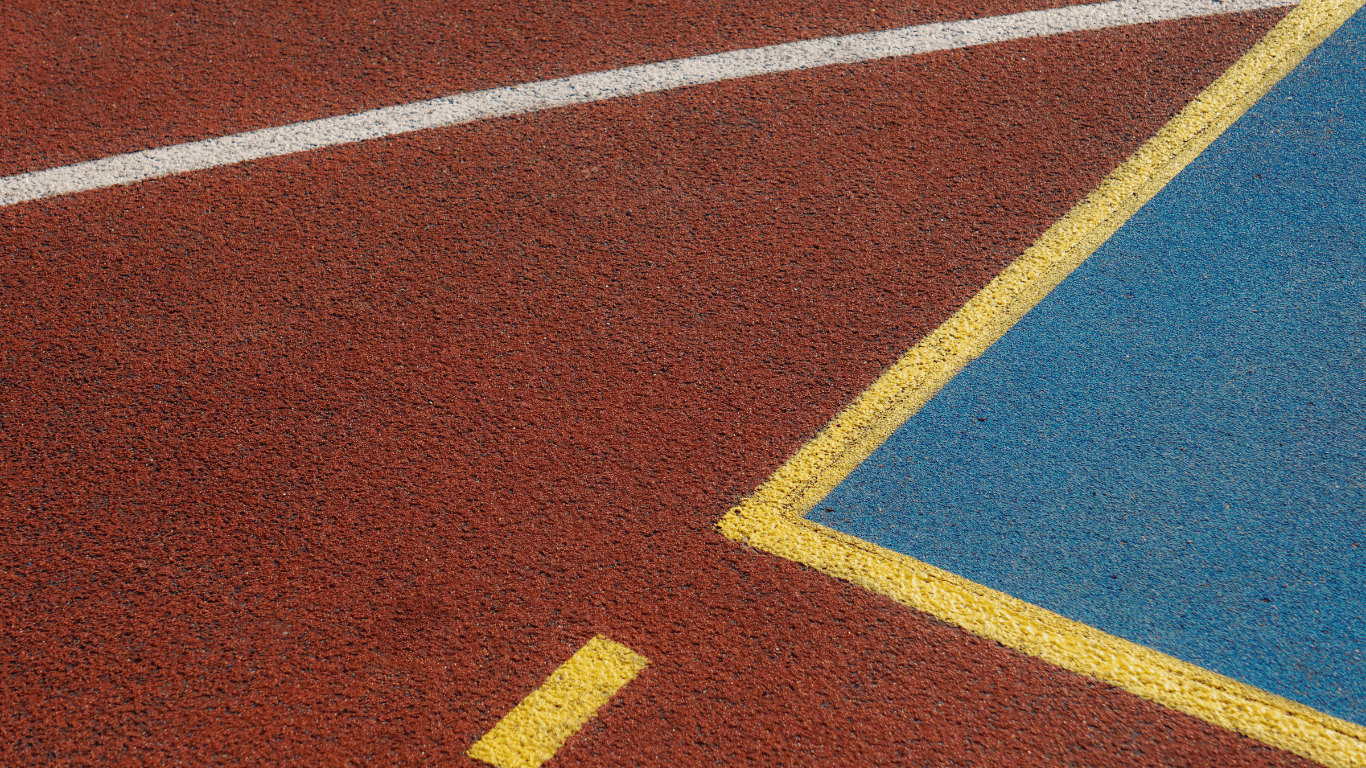 Close-up of textured sport court surface with vibrant colors and clean painted lines after a court installation service in Chandler, AZ