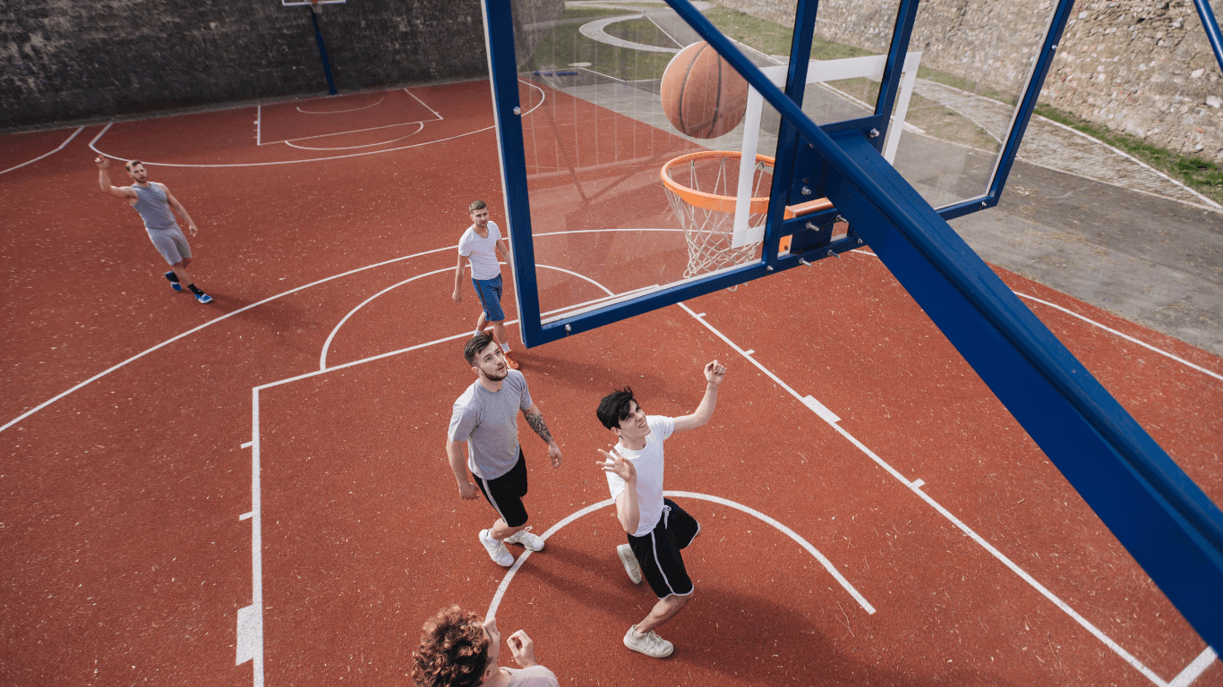 Aerial view of players shooting and defending on a textured basketball court during a court installation service in Chandler, AZ
