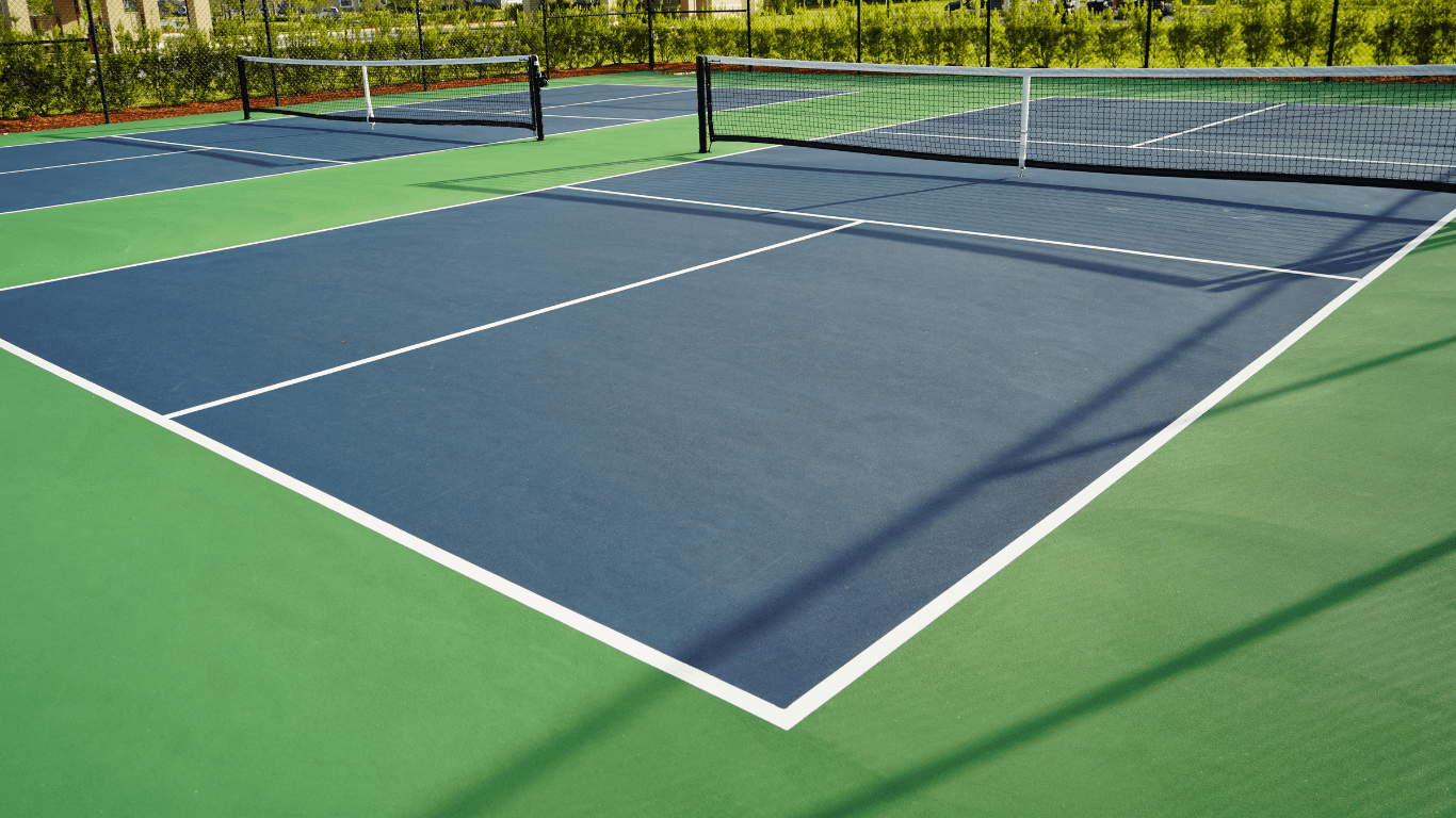 Smooth tennis court with bright white boundary lines and even surface after a court installation service in Chandler, AZ