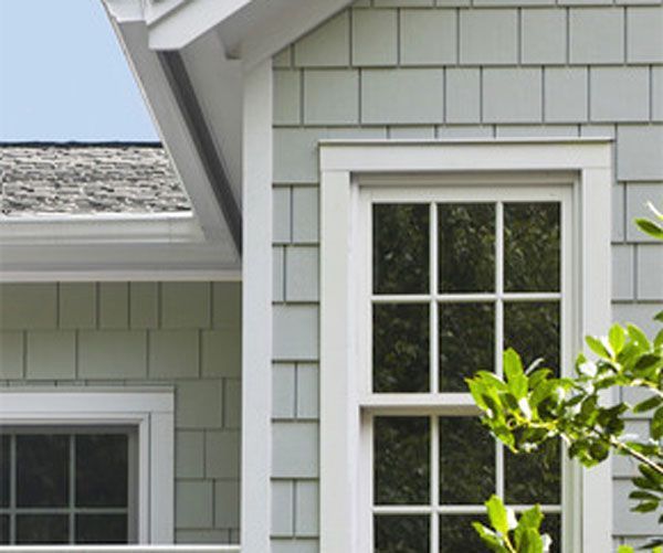 New shingle roof on a brick home with many gables