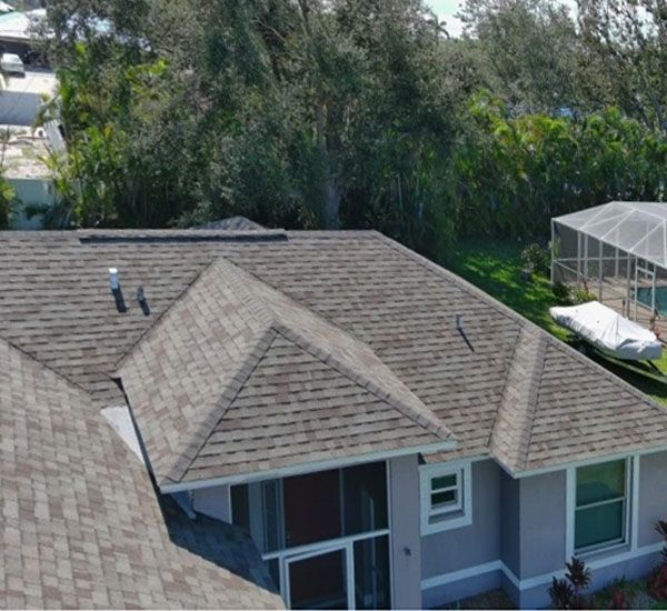 An aerial view of a house with a large roof