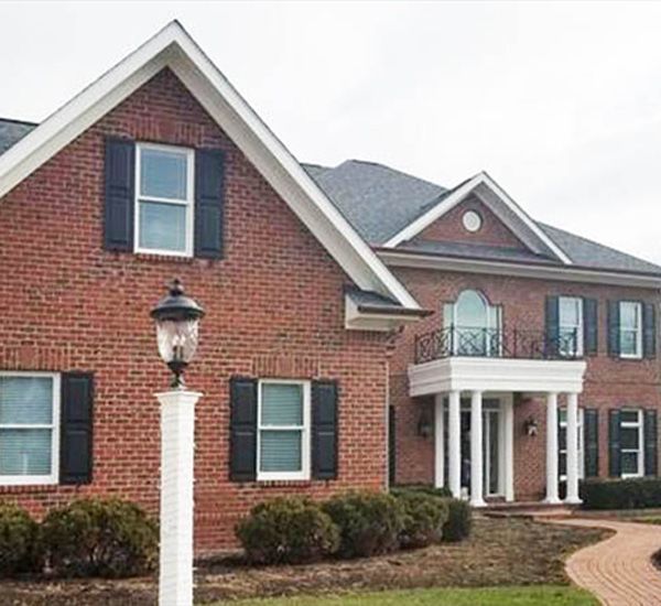 New shingle roof on a brick home with many gables