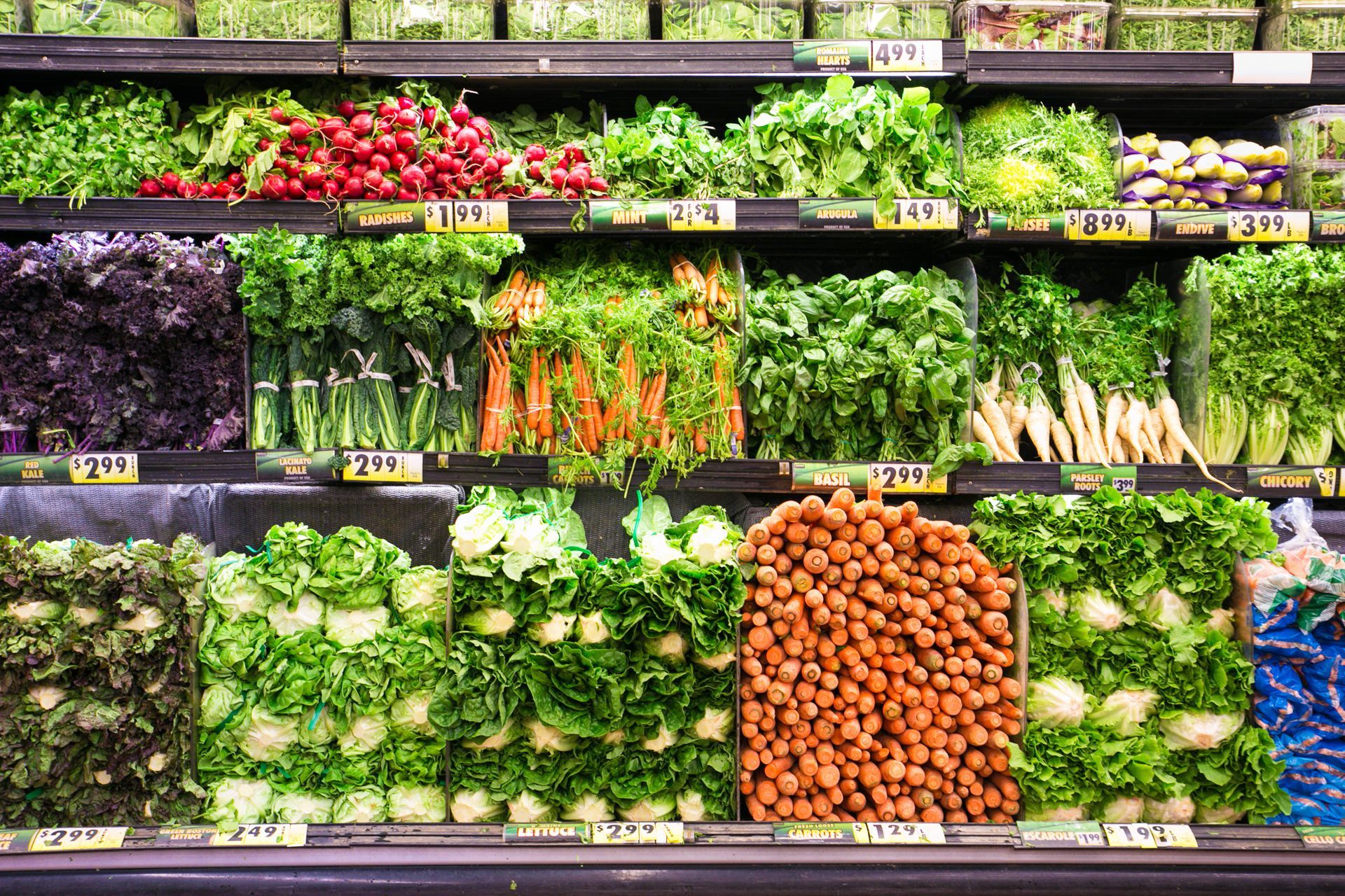 Produce section in a grocery store with assorted fruits and vegetables on display.