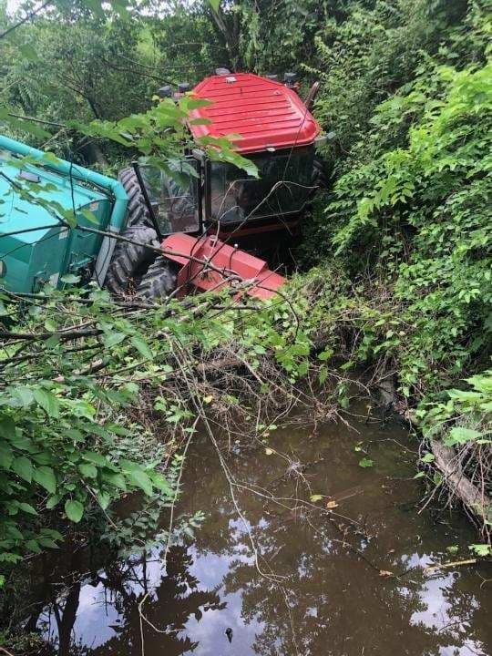 tractor stuck in a flooded ditch