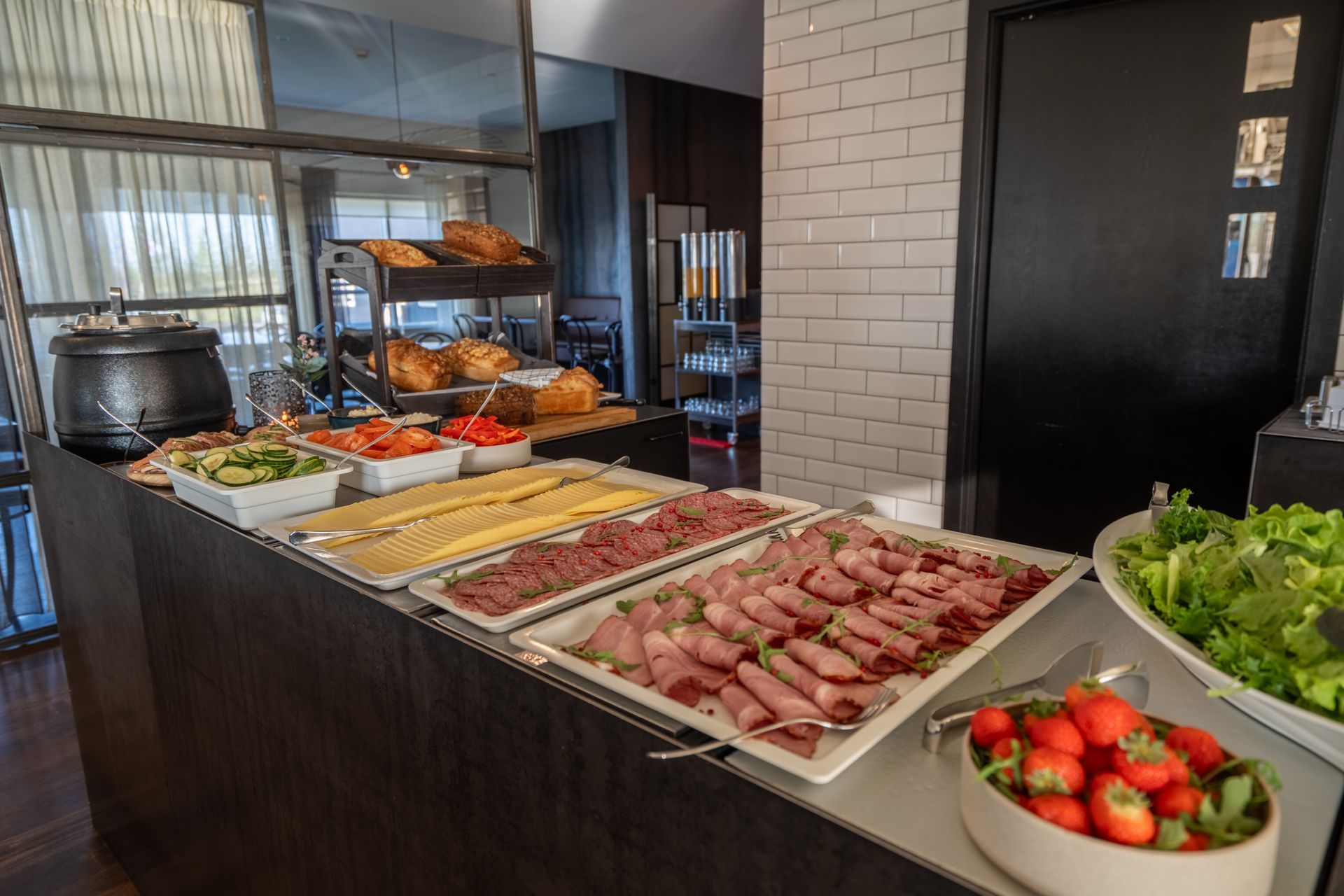 A buffet table with a variety of food on it.