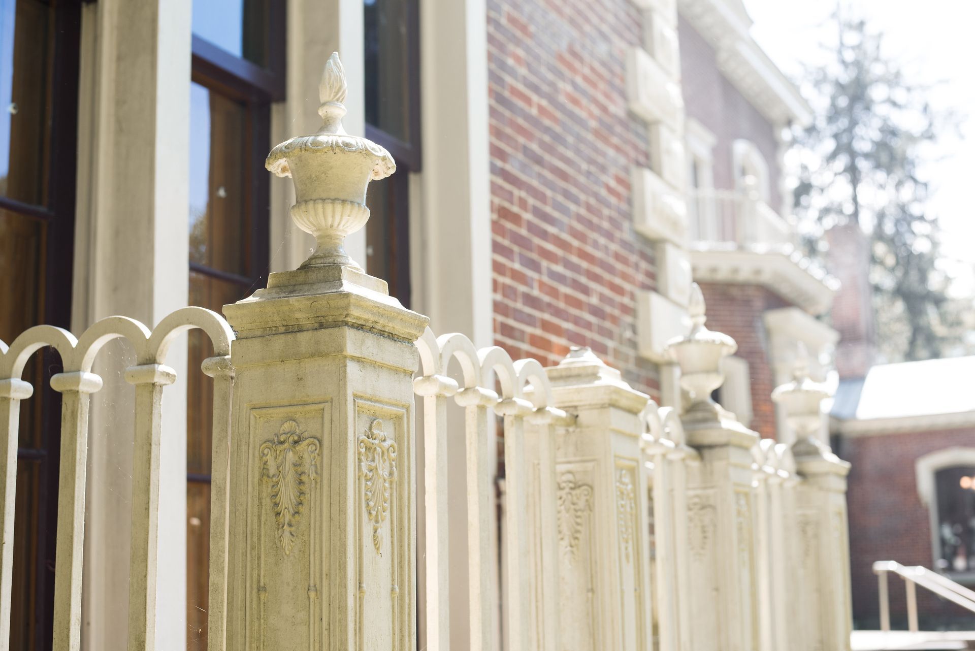 Brick exterior of a house with decorative rails around a porch