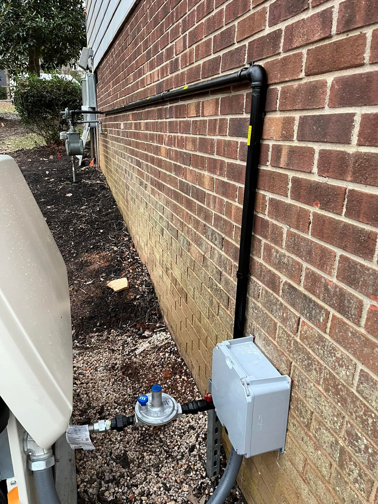 A brick wall with a gas meter attached to it.