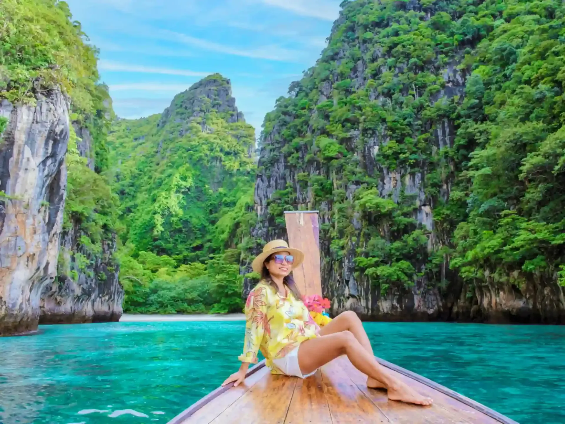 woman sitting at the front of longtail boat