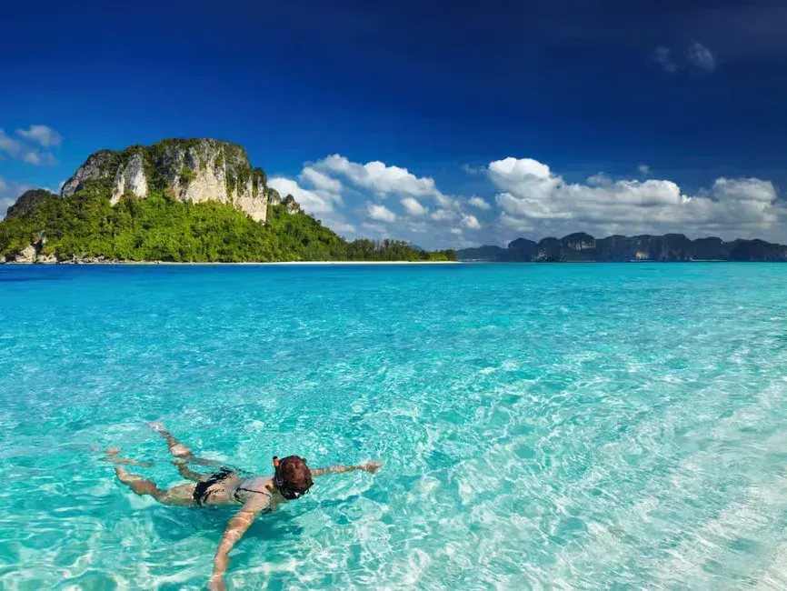 a woman snorkeling in shallow waters