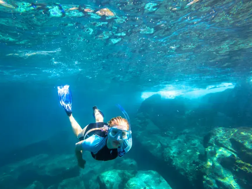 a woman snorkeling in krabi