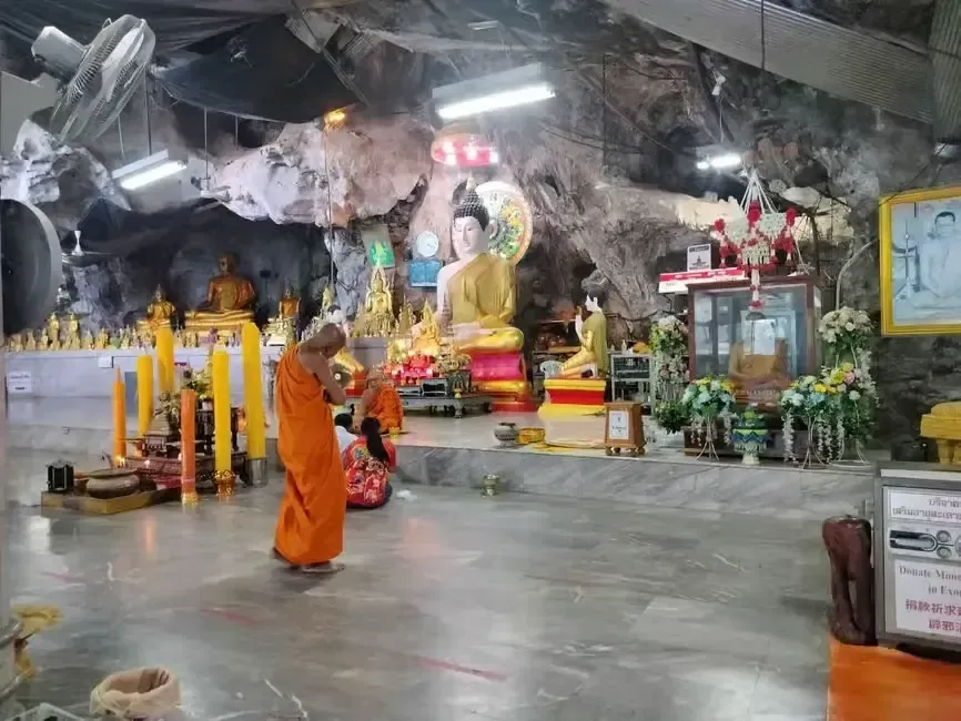a monk praying inside the tiger cave temple