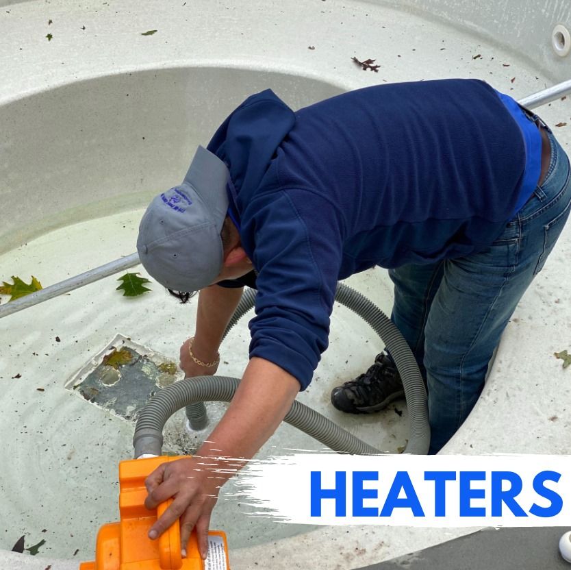 A person in a blue hoodie works on a pool drain with a yellow tool while standing inside an empty, light-colored pool.