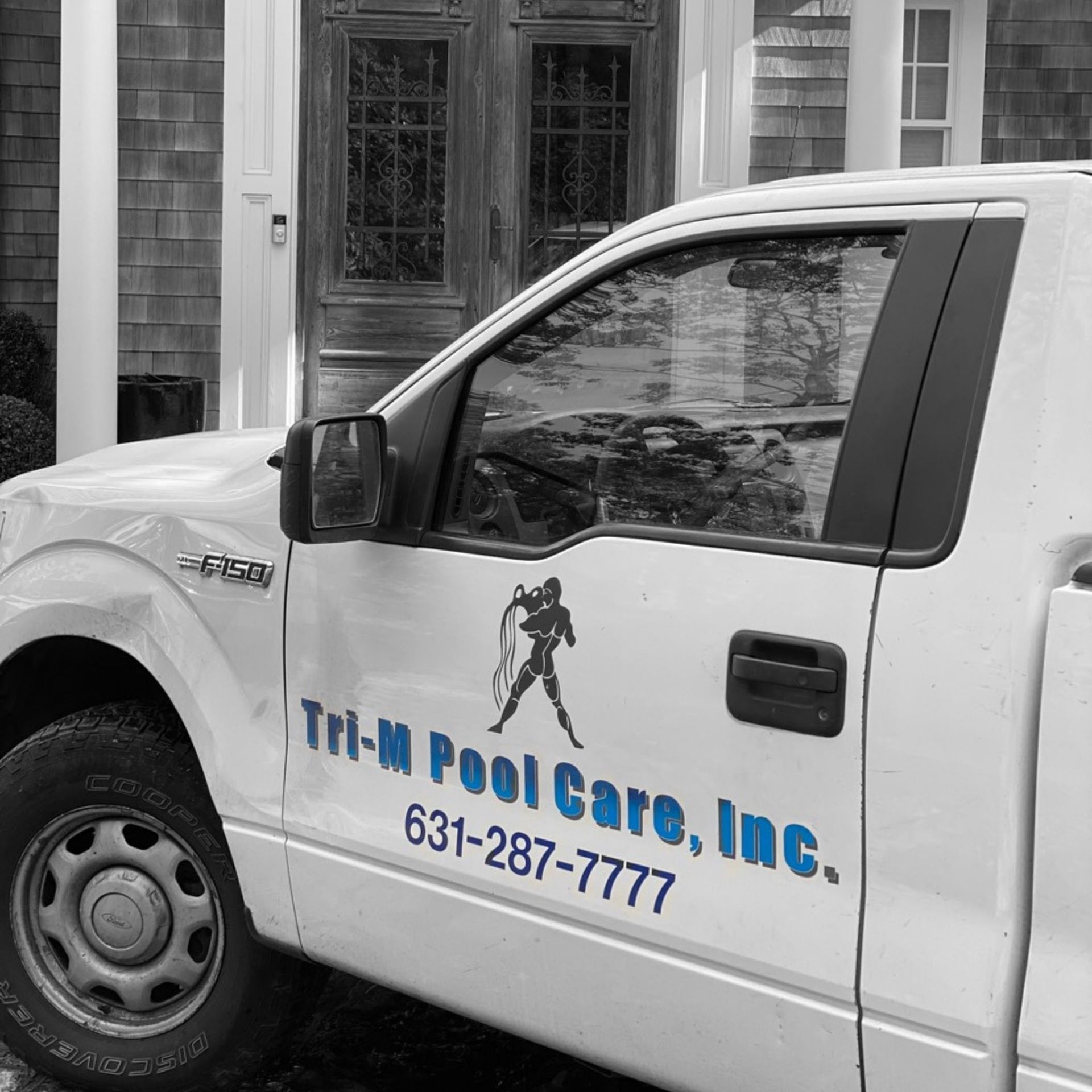 A white service truck with the blue text 