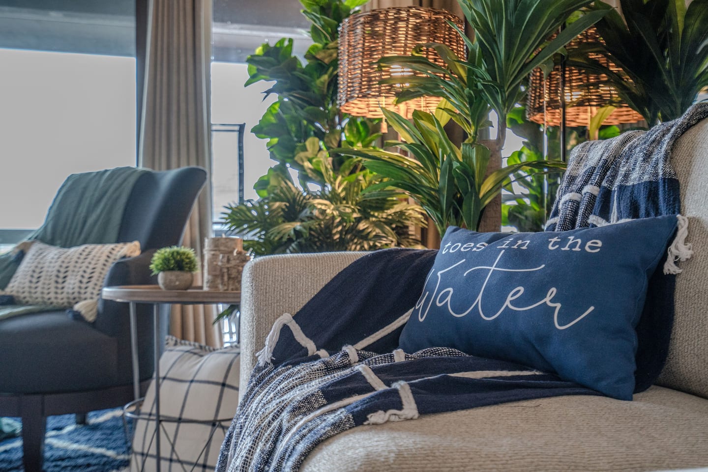 A blue pillow is sitting on a chair in a living room.