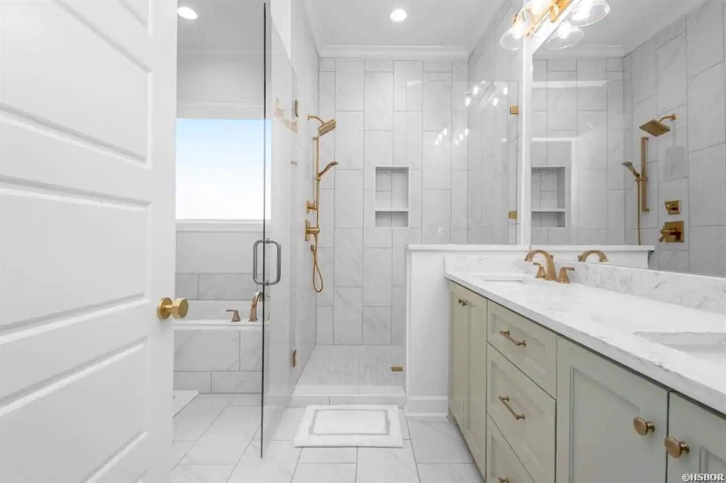 A bathroom with a walk in shower , sink , and mirror.