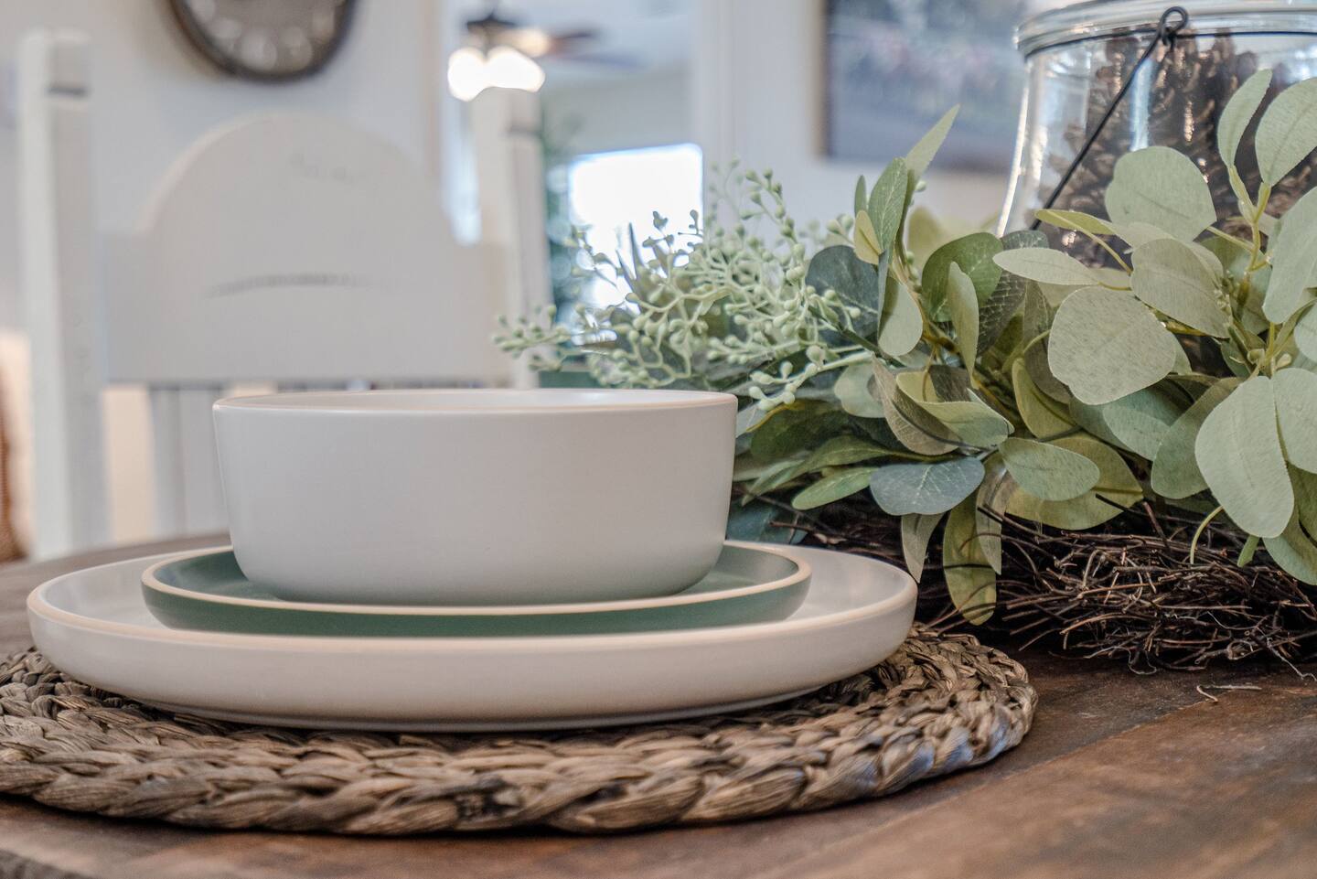 A table with plates and a bowl on it.