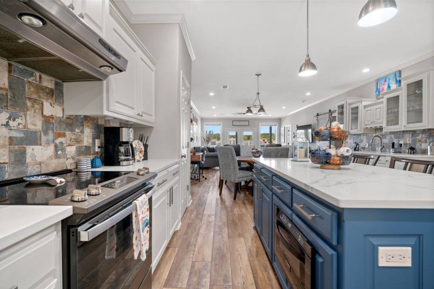 A kitchen with a large island in the middle and a stove.