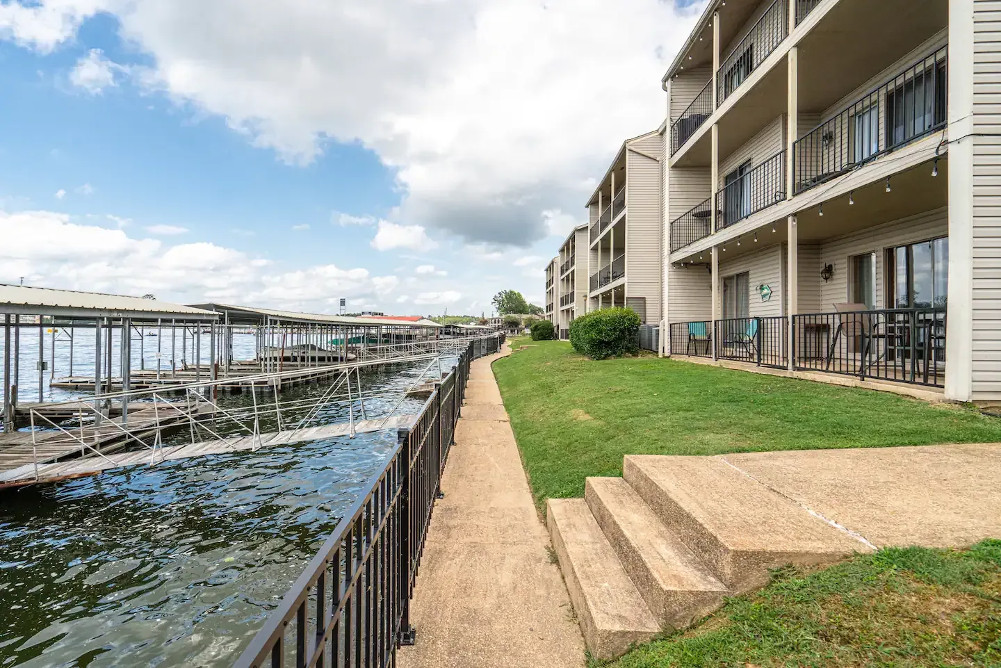 A walkway leading to a building next to a body of water.