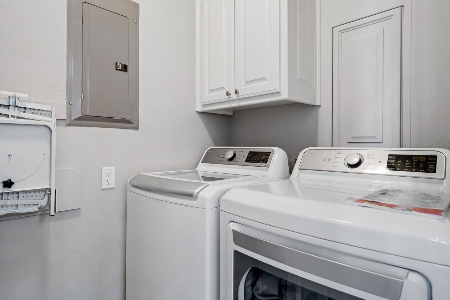 A laundry room with a washer and dryer in it.