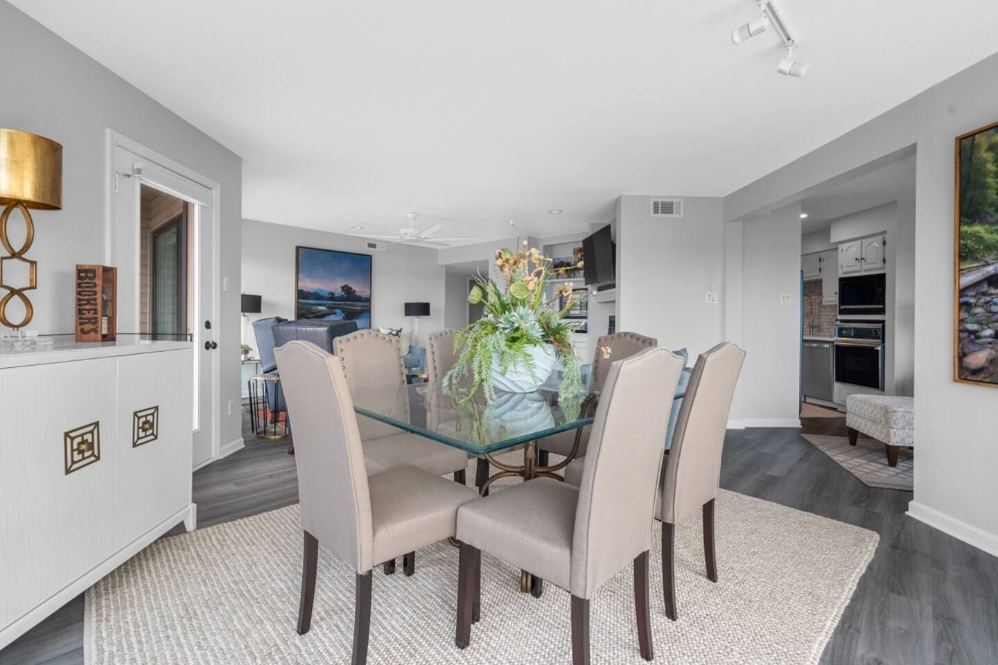A dining room with a glass table and chairs.