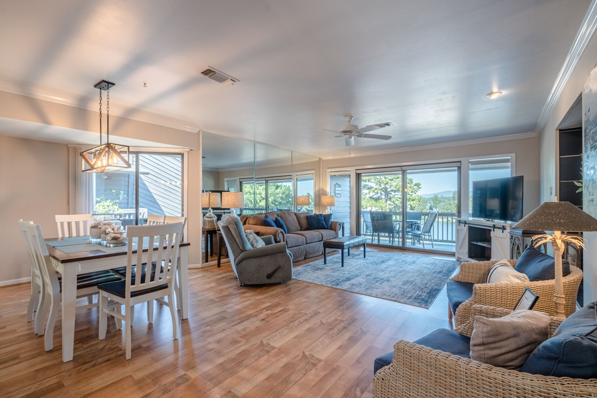 A living room with a couch , chairs , a table and a television.