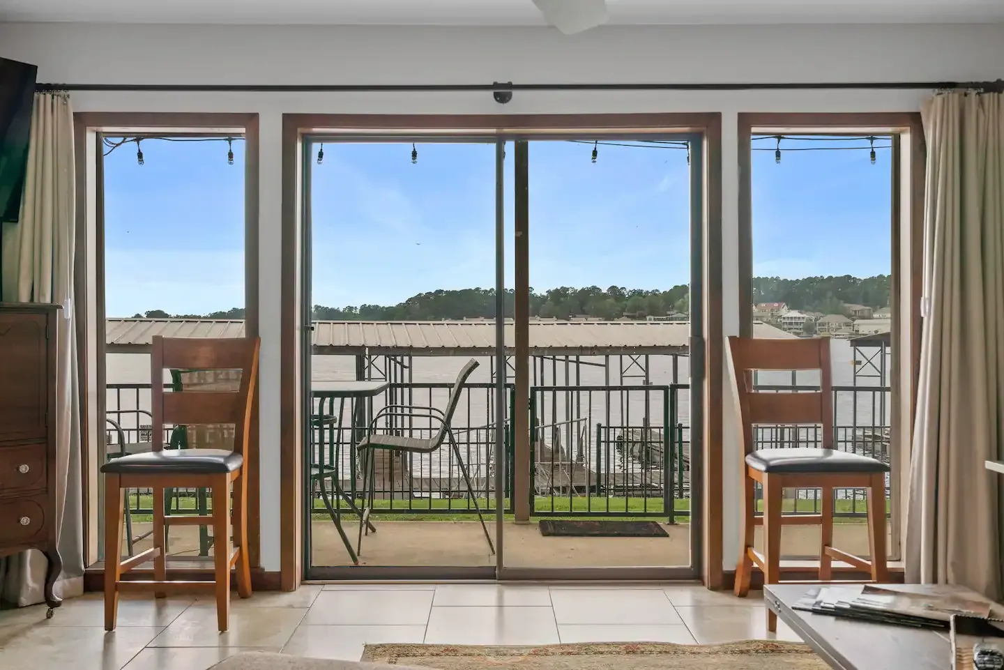 A living room with sliding glass doors leading to a balcony