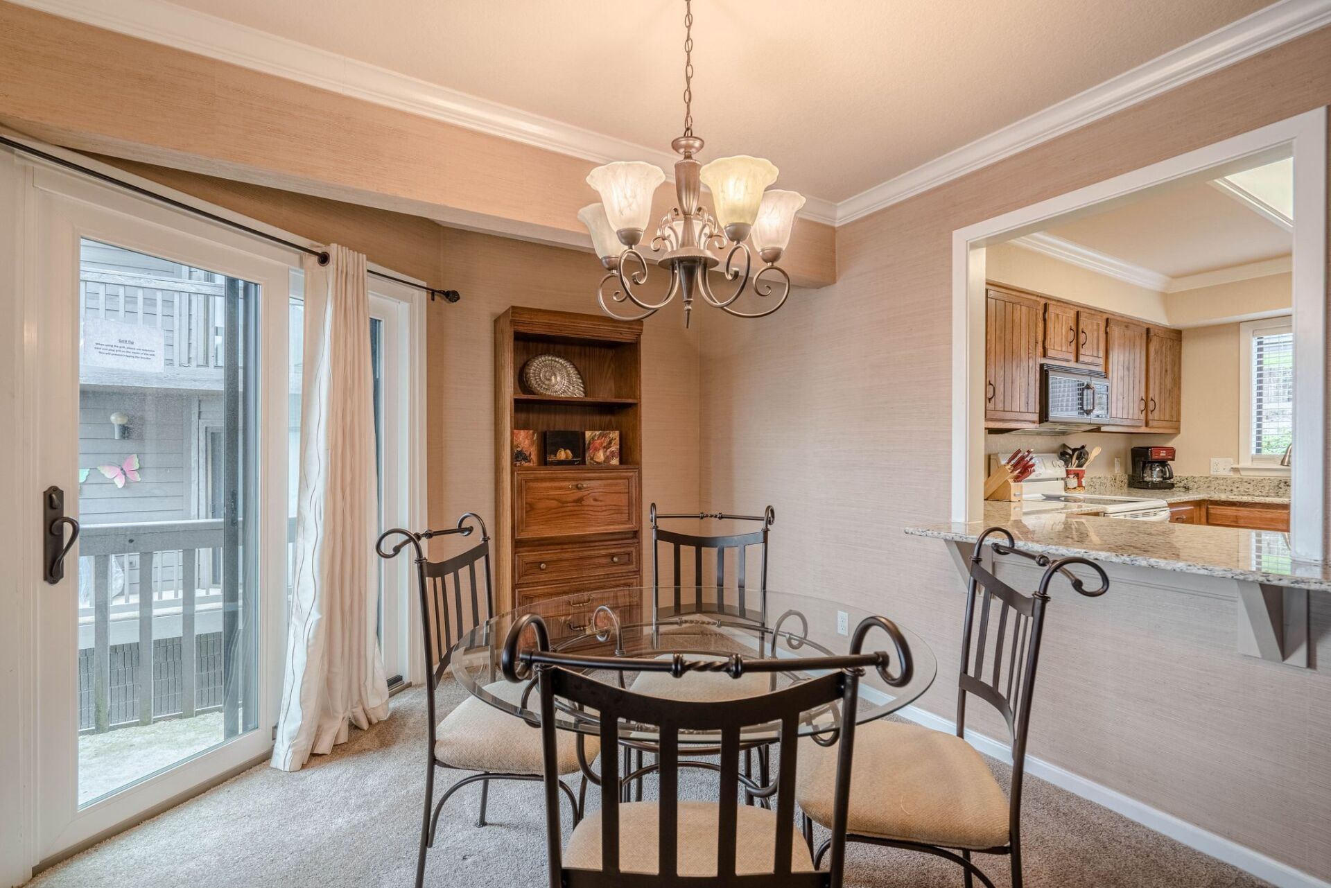 A dining room with a table and chairs and a chandelier.