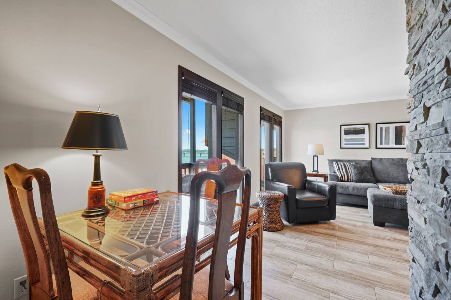 A living room with a table and chairs and a lamp.