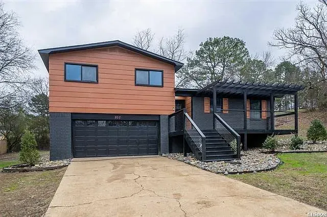 A house with a garage and stairs is for sale.
