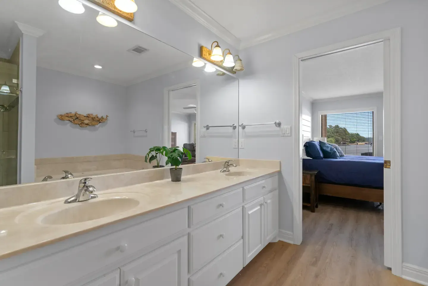 A bathroom with two sinks and a large mirror.