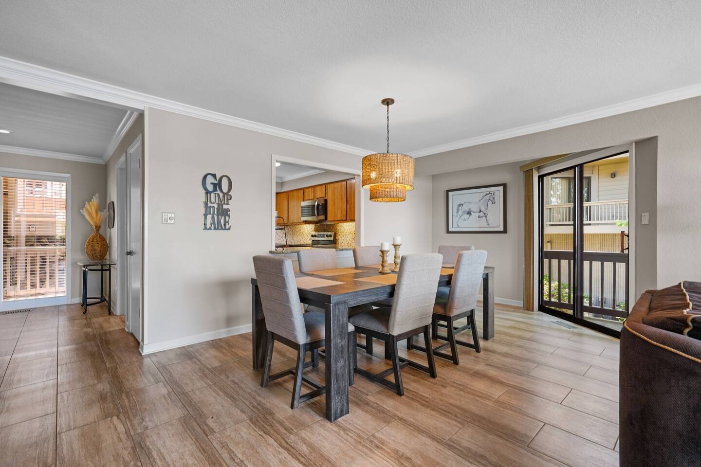 A dining room with a table and chairs and a chandelier.