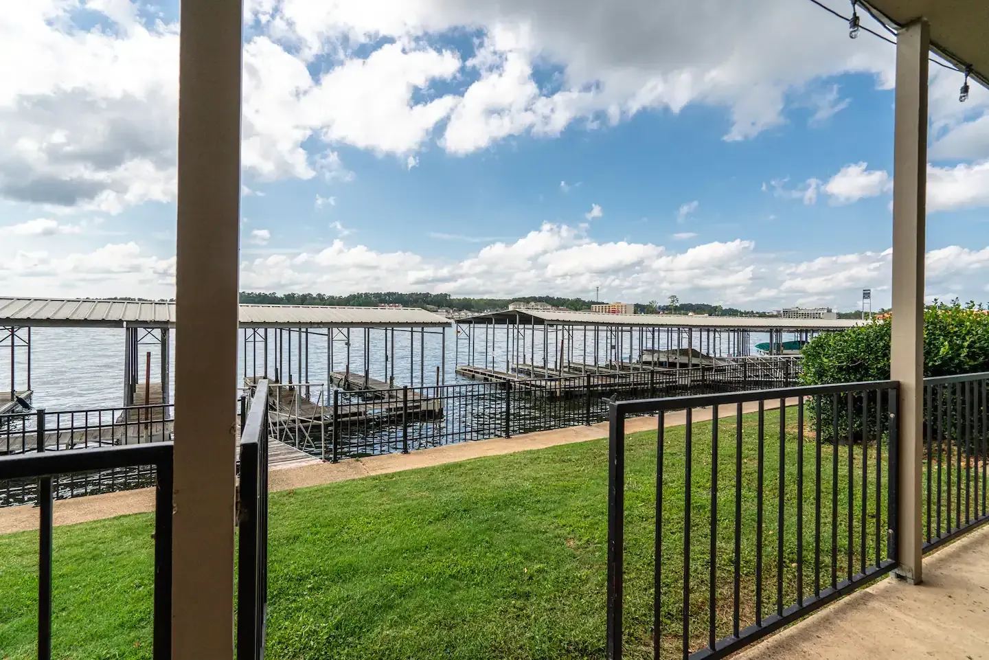 A balcony overlooking a body of water with a dock in the background.