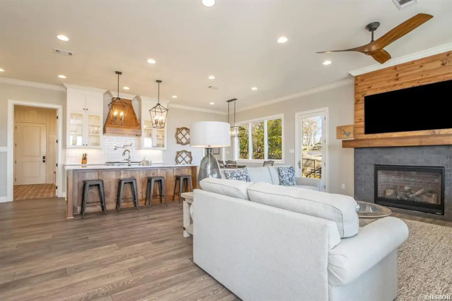 A living room with a couch , fireplace and television.