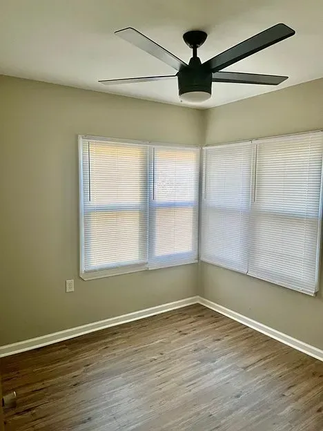There is a ceiling fan in the corner of the room.