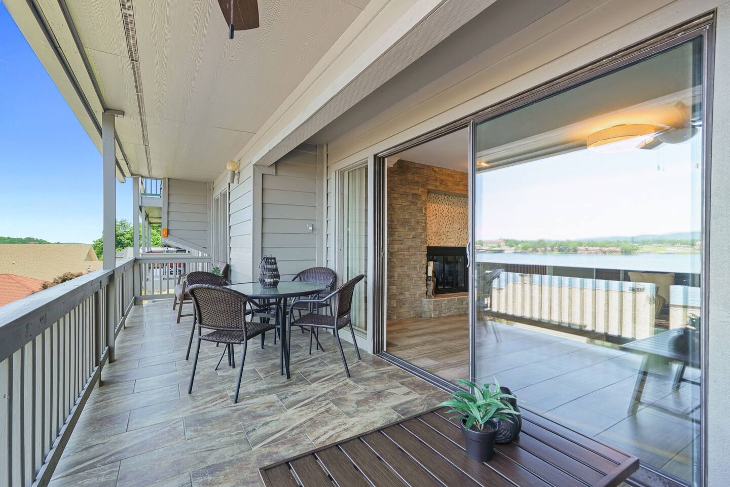 There is a large balcony with a table and chairs on it.