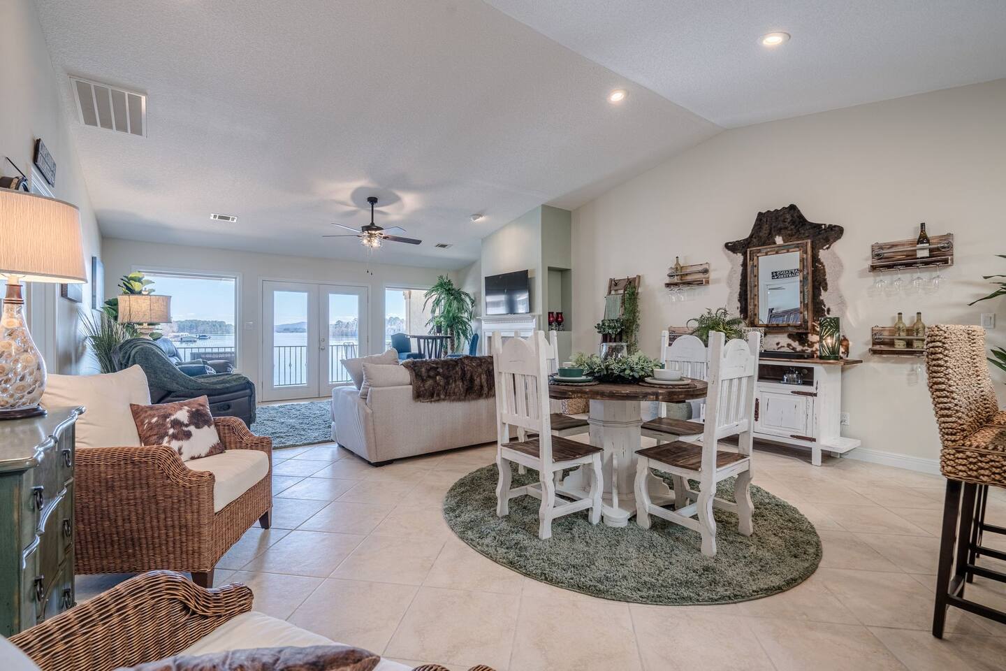 A living room and dining room in a house with a table and chairs.