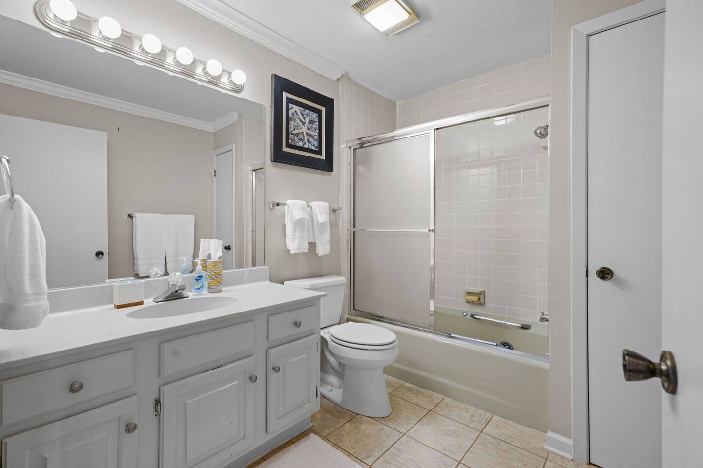 A bathroom with a toilet , sink , and shower.