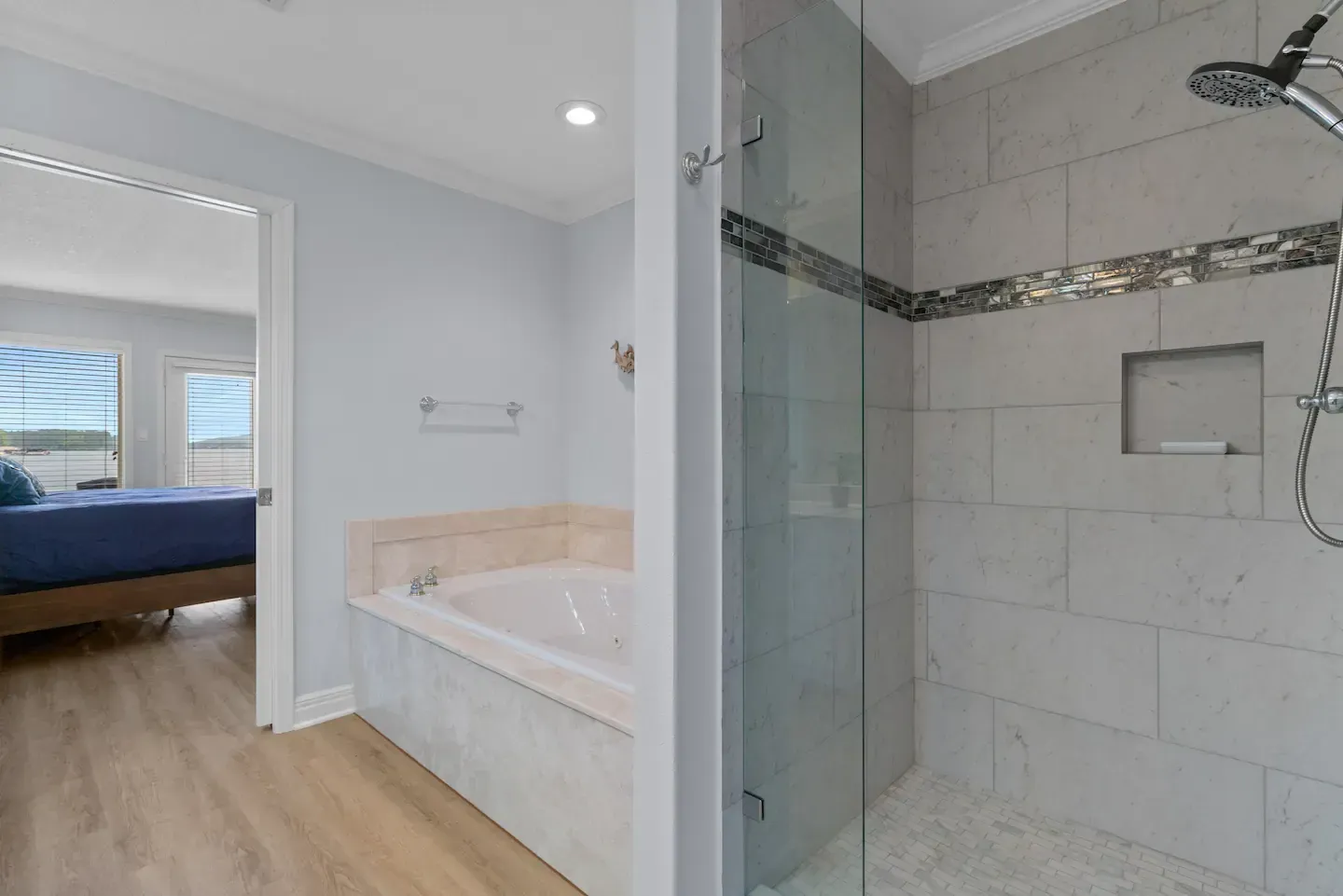 A bathroom with a bathtub and a walk in shower.