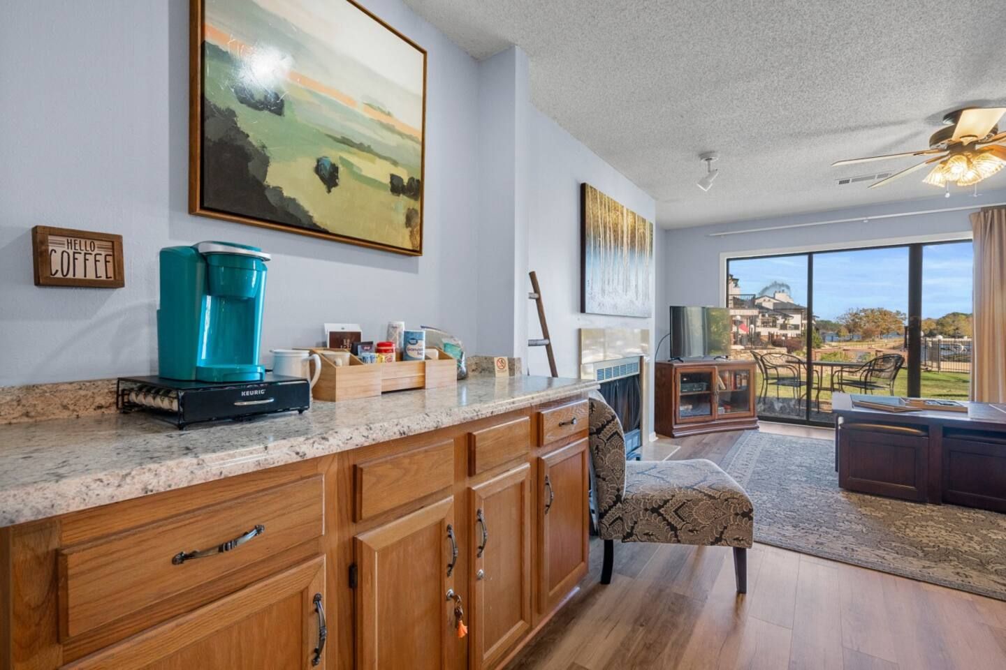 There is a coffee maker on the counter in the living room.