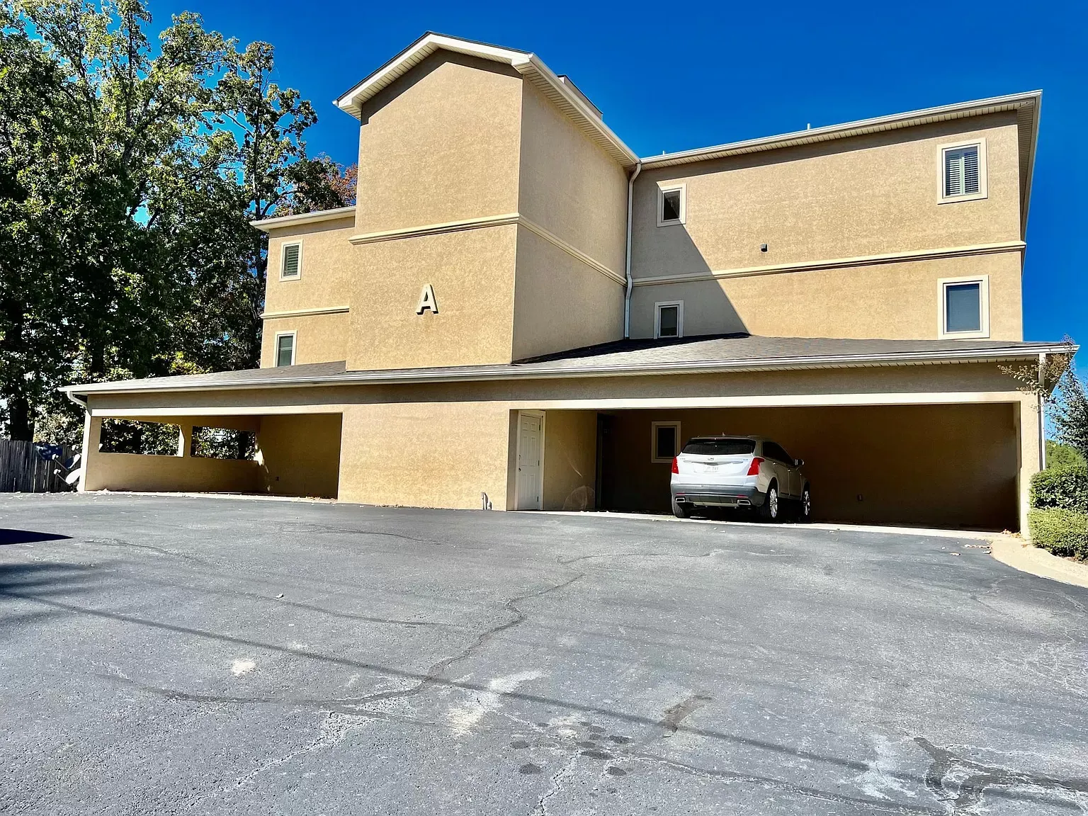 A car is parked in front of a large building